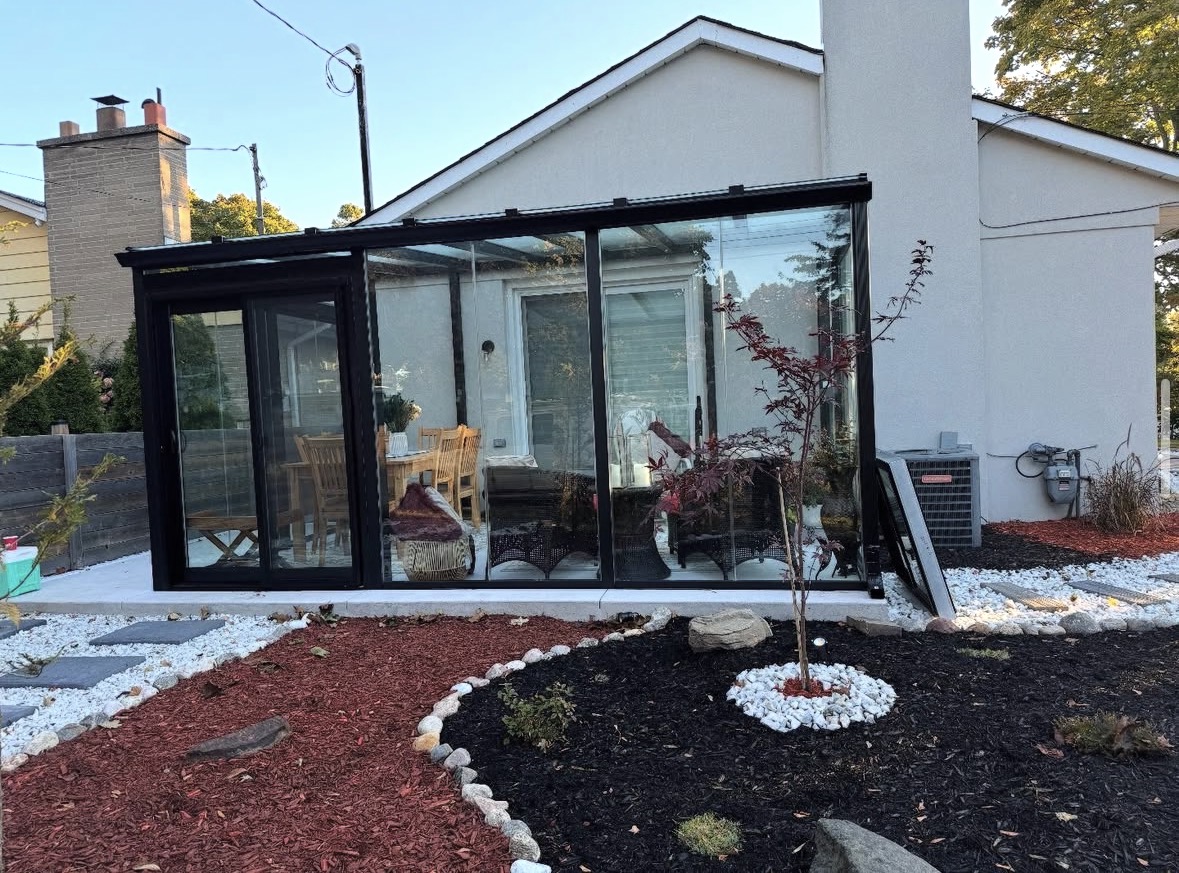 Black lean-to sunroom with landscaping