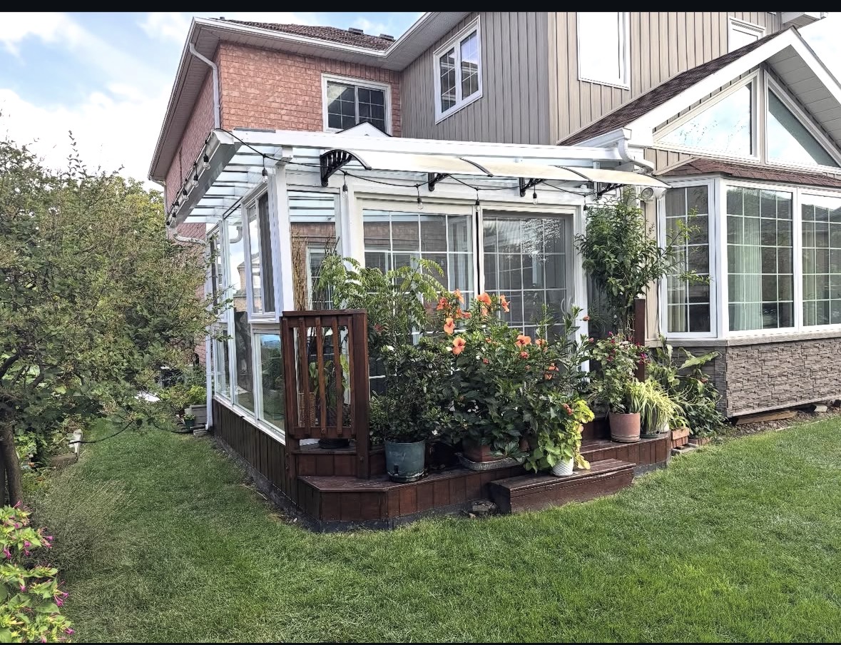 White sunroom with plants and string lights